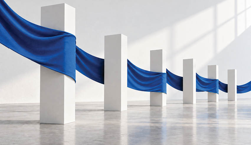 A flowing blue fabric weaves horizontally through a series of tall white rectangular pillars in a minimalist, light-filled space. Description generated by AI